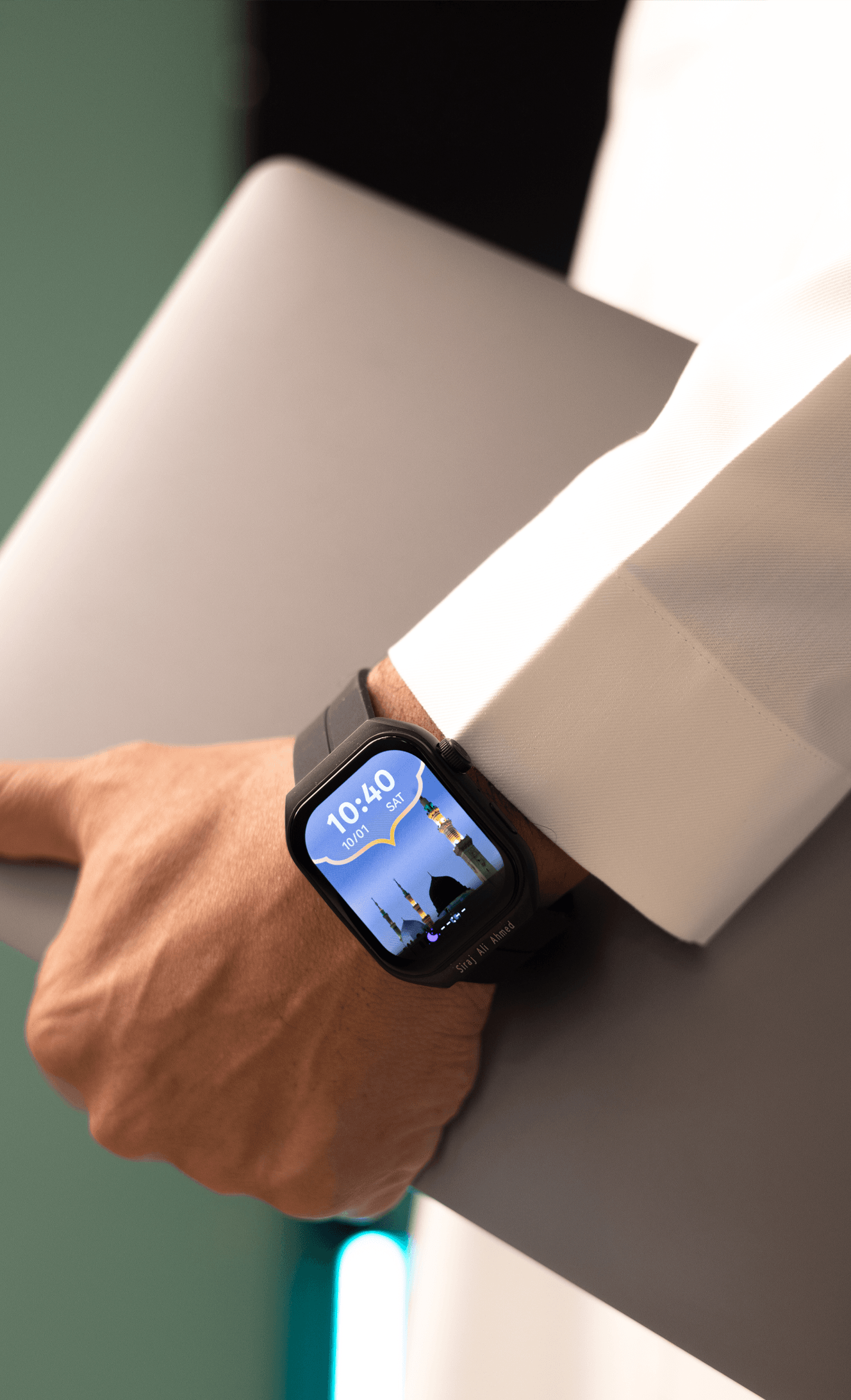 Original close-up of a black M2 Smartwatch worn with a white thobe