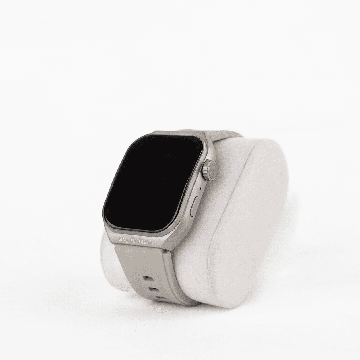Grey M2 Smartwatch with a silver-grey case, displayed on a white cushion