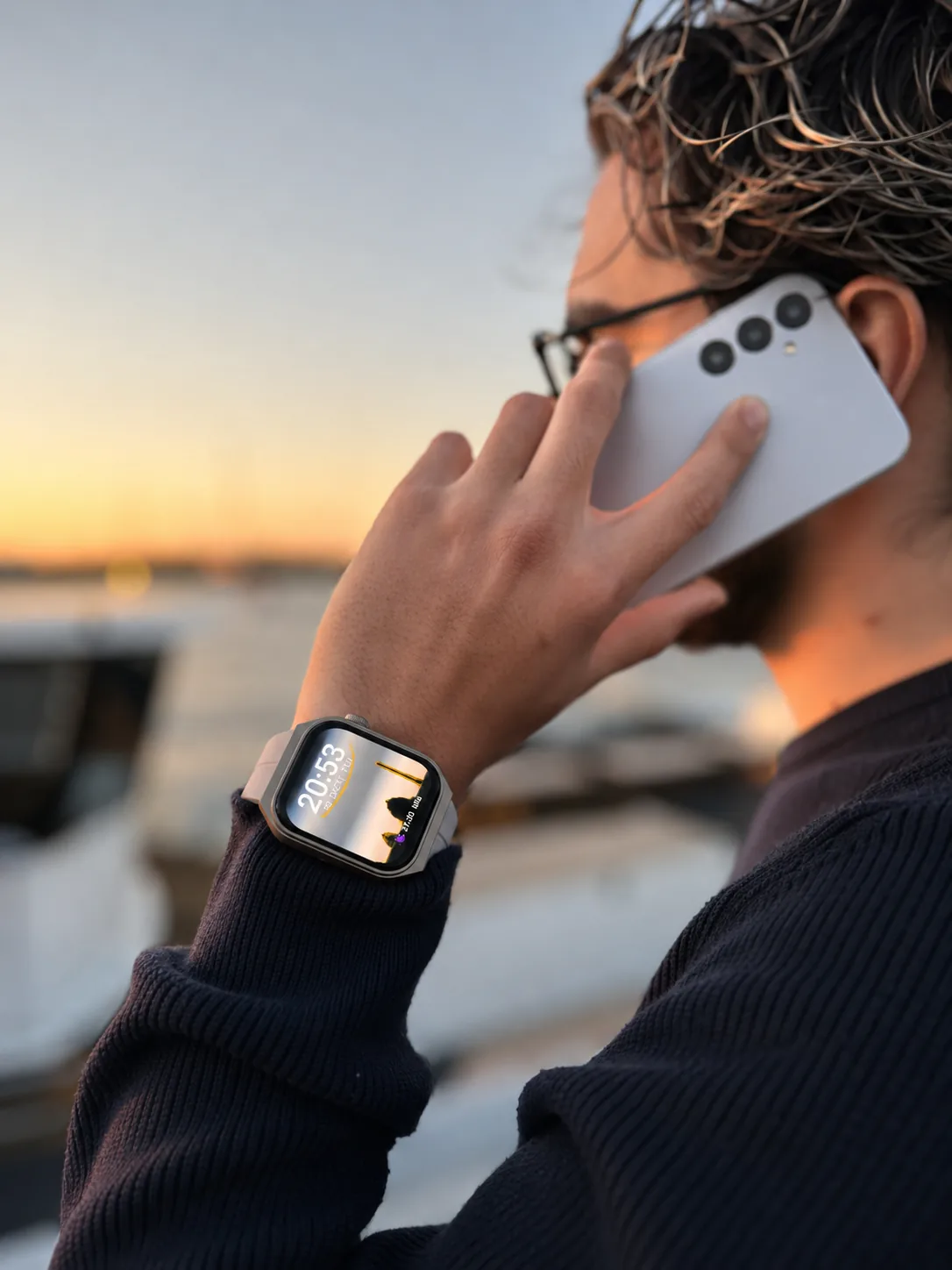 Original close-up of a man wearing a light grey M2 Smartwatch while speaking on his phone
